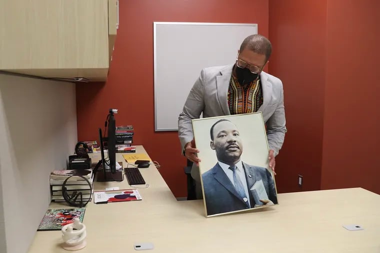 Temple University Professor and Director of the Center for Anti-Racism Timothy Welbeck stands in his new office with a photo of Martin Luther King Jr., in the Center for Anti-Racism in Mazur Hall of the College of Liberal Arts on Monday.
