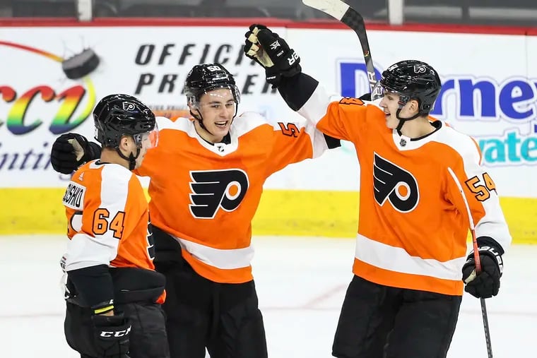 The Flyers' German Rubtsov (center) celebrates his goal against the Islanders during the preseason rookie game on Sept. 11 in Allentown. He made his NHL debut Friday in New Jersey.