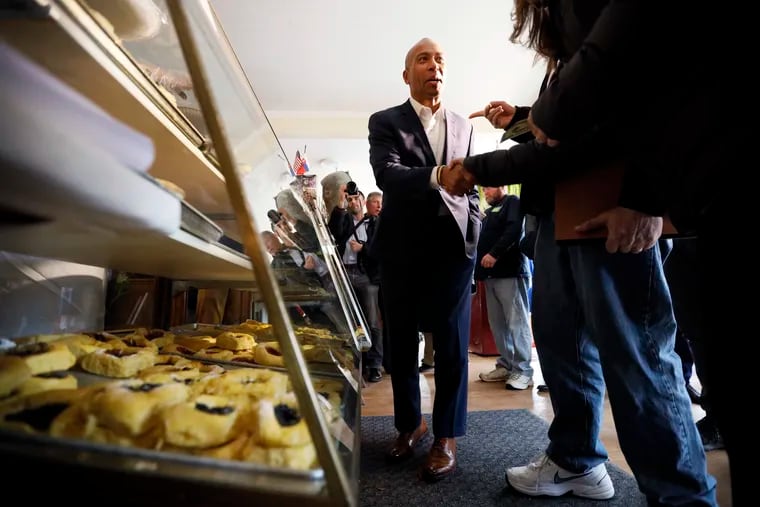 Democratic presidential candidate former Massachusetts Gov. Deval Patrick talks to local residents after placing his order at the Sykora Bakery, Monday, Nov. 18, 2019, in Cedar Rapids, Iowa.