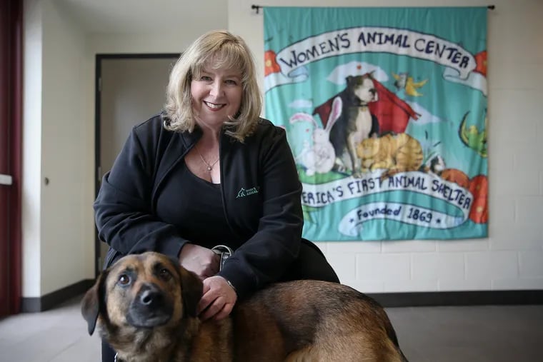 CEO Cathy Malkemes with her dog, Maggie, at the Women's Animal Center in Bensalem. Malkemes adopted Maggie five years ago after the two bonded at the center. The organization, founded 150 years ago, now includes a veterinary hospital and an animal shelter.