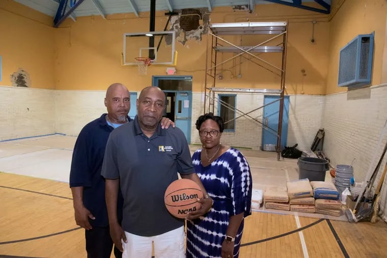 Cecil B. Moore Recreation Center leaders (from left) Verland Wayns, facility caretaker; Sam Owen, rec center leader; and LeShadae Godfrey, assistant rec leader, in the gym that is closed to the kids for six weeks for much-needed repairs. Many rec centers around the city could use money generated from the mayor's proposed soda tax.