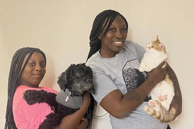 Carina Cheatham (right), a.k.a. Nina Love, founder of The Black Thornberry animal rescue, with her daughter Arianna (left) and their pets they rescued as strays, Milo the cat and Stitch the poodle.