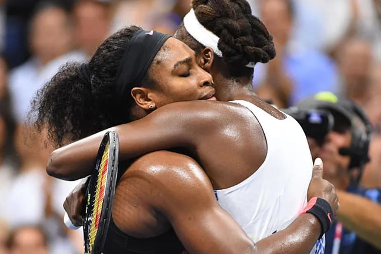 Serena Williams of the USA (left) hugs sister Venus Williams of the USA after their match on day nine of the 2015 U.S. Open tennis tournament at USTA Billie Jean King National Tennis Center.