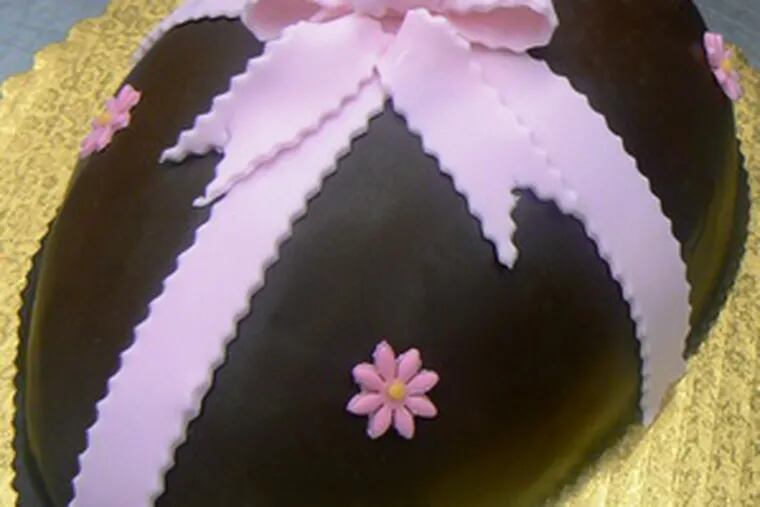 With a shell of chocolate frosting to decorate, an Easter egg cake can be a project that keeps youngsters involved.