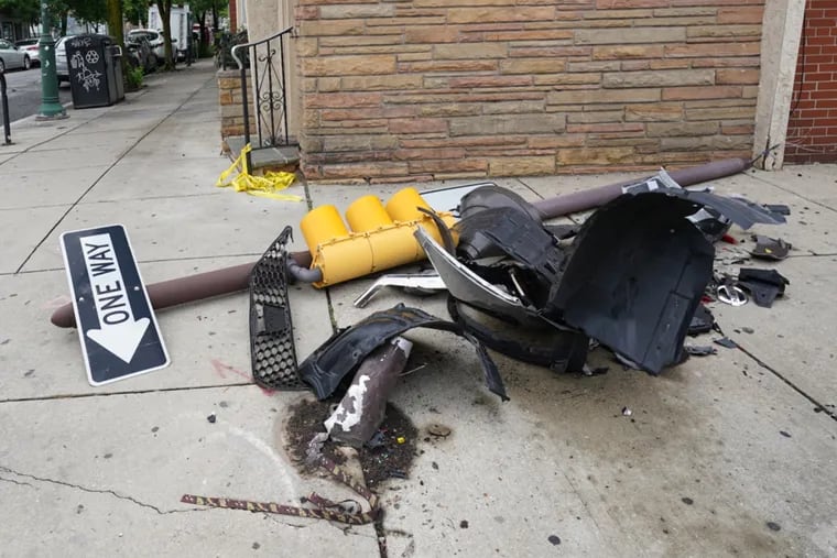 Pieces of a downed streetlight at 15th and South Streets. After an alleged road rage incident, the shooter hit three cars and fled after killing a 17-year-old driver.