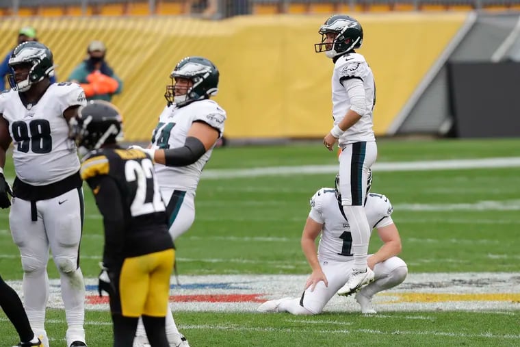 Eagles kicker Jake Elliott leaps in disappointment as he watches his a 57-yard, fourth-quarter field goal attempt against the Steelers on Sunday sail wide right.