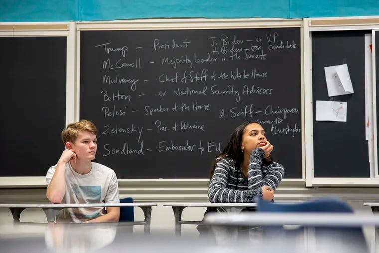 Twelfth-grade students Jess Anderson, 17, of Bala Cynwyd, Pa., left, and Carmen Williams, 17, of Voorhees, N.J., right, at William Penn Charter School, learn about the impeachment proceedings.