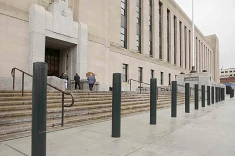 Market Street entrance of the new IRS building with its ugly ring of bollards. Other designers have achieved the same protection with an attractive mix of concrete benches and planters. (Michael Bryant / Staff Photographer)
