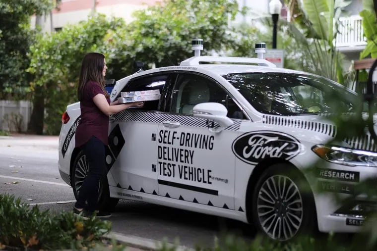 A self-driving vehicle from Ford delivers Domino's Pizza in Miami, Fla. Ford is making Miami-Dade County its new test bed for self-driving vehicles.