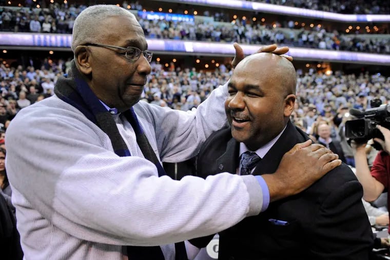 This March 2013 photo shows former Georgetown coach John Thompson, left, congratulating his son Georgetown head coach John Thompson III after the Hoyas' 61-39 win over Syracuse in Washington.