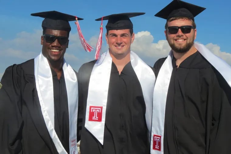 Temple Owls defensive end Jacob Martin, quarterback Frank Nutile and offensive tackle Cole Boozer (from left to right) in their academic regalia on the beach.