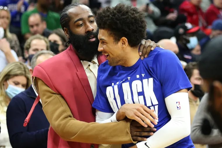 James Harden, left, of the Sixers jokes with new teammate Matisse Thybulle before  their game at the Wells Fargo Center on Feb. 15, 2022.