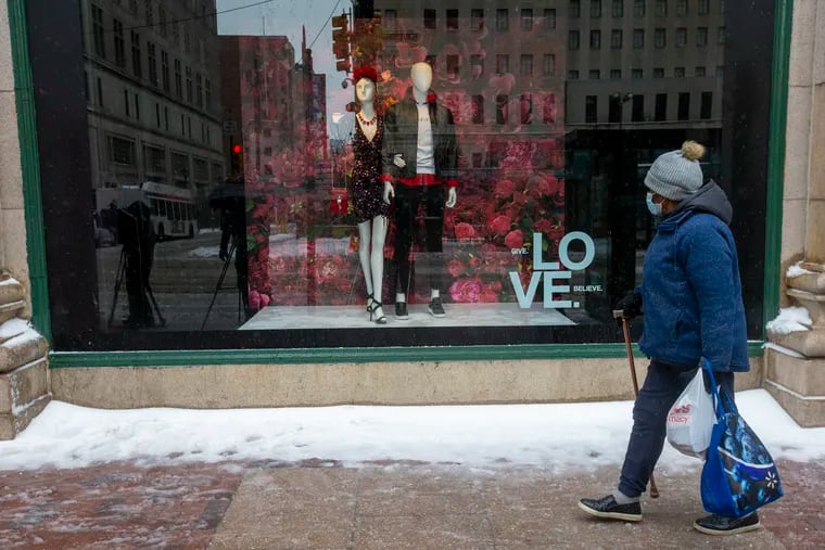 A woman at the window display at the Macy's Department in Center City Philadelphia after overnight snow fell in February.