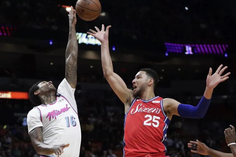 Ben Simmons has his shot blocked by Heat forward James Johnson (left) in the Sixers’ loss on Thursday.