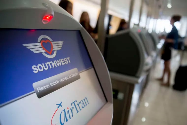 Ticket kiosk for recently merged Southwest and AirTran. Based on its good quarter, Southwest said it would award each employee a $200 bonus.