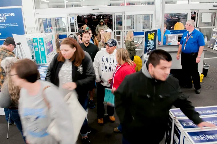 FILE- In this Nov. 23, 2017, file photo shoppers enter a Best Buy looking for early Black Friday deals on Thanksgiving Day in Bowling Green, Ky. A solid 70 percent of Americans plan to shop on Black Friday this year, according to a recent NerdWallet study conducted by The Harris Poll. (Bac Totrong/Daily News via AP, File)