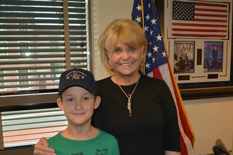 Alex Collins, 9, with Sheriff Carolyn Welsh of Chester County, Pa.