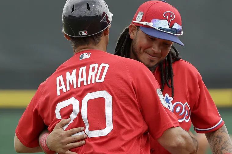 Phillies shortstop Freddy Galvis hugs Red Sox third base coach Ruben Amaro Jr. during spring training.