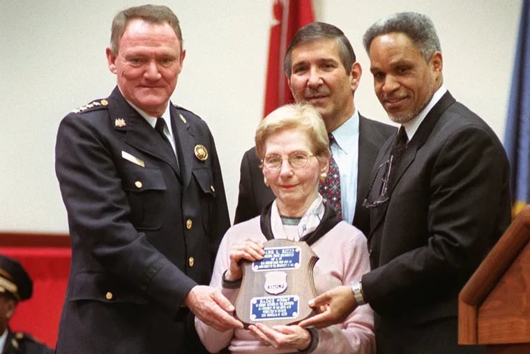 Carmella Rizzo is seen at the graduation ceremony of the Philadelphia Police College Class 331 and the retiring of the badge of hr husband, former Mayor Frank Rizzo. She is flanked byJohn F. Timoney, left, and John Street. Directly behind Mrs. Rizzo is her son, Francis S. Rizzo.