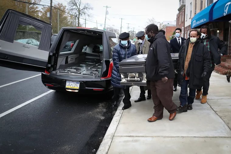 Pallbearers walk the casket carrying Henry James to the hearse in front of the Terry Funeral Home in Philadelphia on April 18. Mr. James died of Covid-19 on April 4.