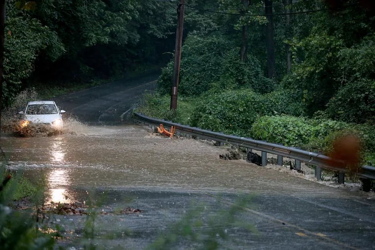 A car navigates a flooded Westtown Road at Chateau Drive in Westtown Township on Sept. 1, 2021.