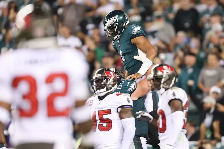 Eagles quarterback Jalen Hurts celebrates his fourth quarter touchdown run with teammate offensive guard Landon Dickerson against the Tampa Bay Buccaneers on Thursday, October 14, 2021 in Philadelphia.
