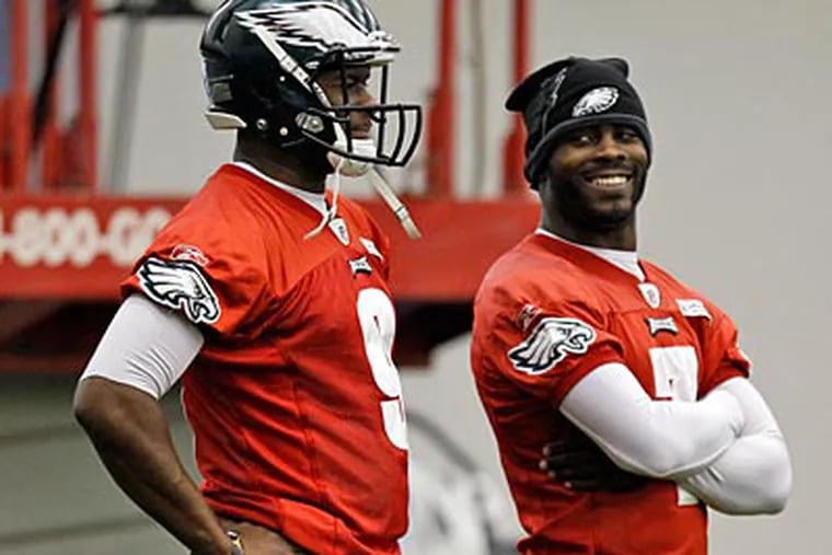 Michael Vick watched as Vince Young took snaps at practice Wednesday. (Alex Brandon/AP)