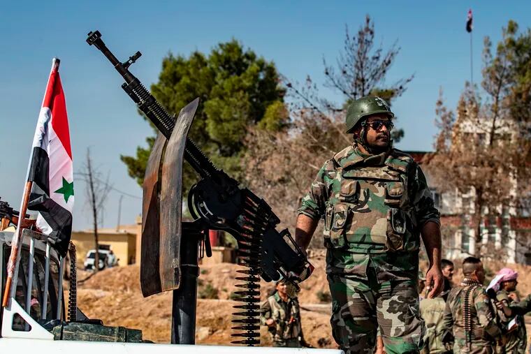 Syrian government forces arrive in the town of Tal Tamr, not far from the flashpoint Kurdish Syrian town of Ras al-Ain on the border with Turkey, which has been a key target of Turkish forces and their proxies since they launched their military assault.