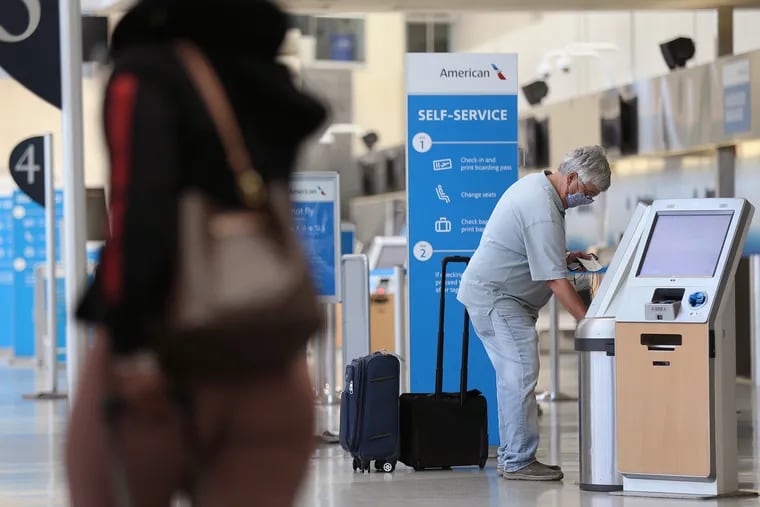 A passenger checks in at Philadelphia International Airport on June 30, 2020. Amid the pandemic, the airport is in danger of having to lay off staff if it does not obtain additional federal aid, PHL's CEO said Friday.