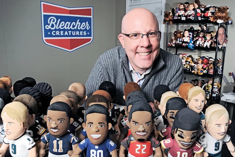 Matthew Hoffman, founder and president of Bleacher Creatures, with some of his creations -- stuffed likenesses of professional sports personalities in his Plymouth Meeting offices. (CLEM MURRAY / Staff Photographer)