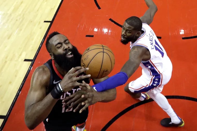 James Harden is fouled by the Sixers' James Ennis during the first half.