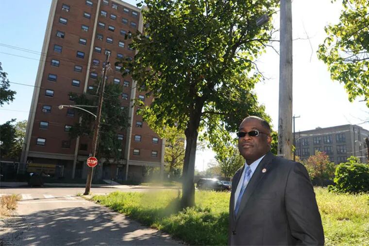Kelvin Jeremiah , chief executive of the Philadelphia Housing Authority , stands in a vacant lot across from the Norman Blumberg Apartments, which are at the center of a revitalization effort.