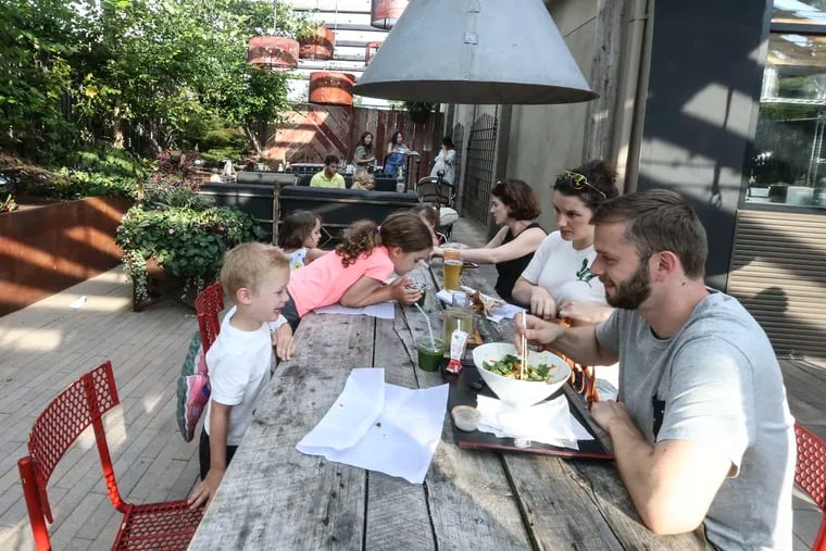 Families enjoy dinner at the Market at the Fareway. Residents in Chestnut Hill have sued the owners of the beer garden (Market at the Fareway) arguing that the pizza and beer spot is a nuisance.