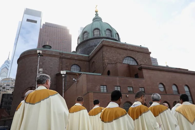 Priests line up outside for the procession into the installation Mass of Archbishop Nelson Pérez at the Cathedral Basilica of SS. Peter and Paul in Philadelphia on Tuesday, Feb. 18, 2020. Philadelphia-area Catholics are grappling with ways to celebrate Holy Week when there won't be in-person services.