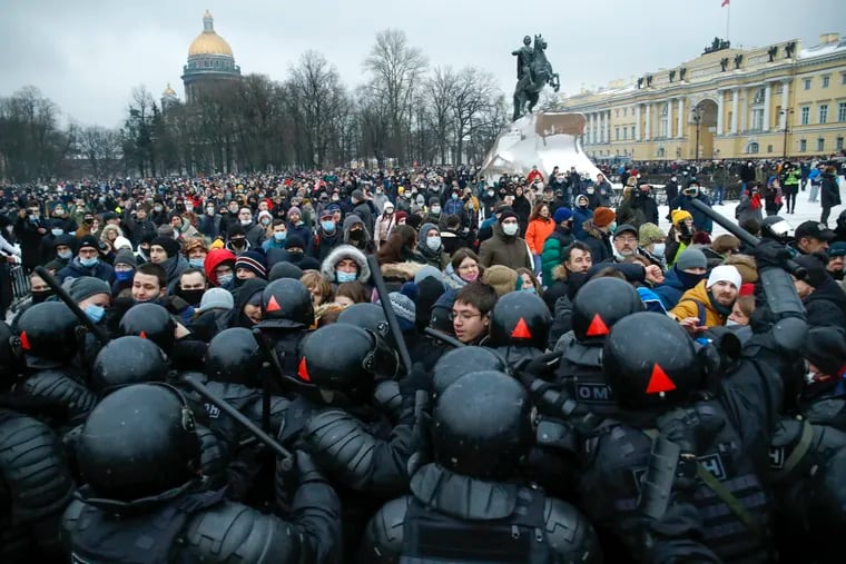 People clash with police during a protest against the jailing of opposition leader Alexei Navalny in St.Petersburg, Russia, Saturday, Jan. 23, 2021. Russian police on Saturday arrested hundreds of protesters who took to the streets in temperatures as low as minus-50 C (minus-58 F) to demand the release of Alexei Navalny, the country's top opposition figure. A Navalny, President Vladimir Putin's most prominent foe, was arrested on Jan. 17 when he returned to Moscow from Germany, where he had spent five months recovering from a severe nerve-agent poisoning that he blames on the Kremlin.