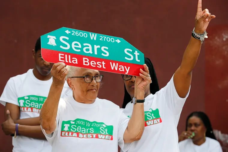 Queenie Pridgen holds a replica street sign in honor of her daughter, Ella Pridgen-Best, at the renaming of the 2700 block of Sears Street to honor the late community activist.
