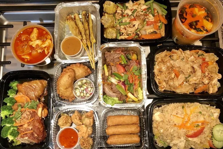 An array of dishes from House of Thai in Northeast Philadelphia made a flavorful takeout feast.  Included here, clockwise from the bottom, crispy honey duck, chicken in red curry, chicken satay, special basil dumplings, drunken noodles, pineapple fried rice, spring rolls, golden bags, chicken curry puffs, grilled beef salad.