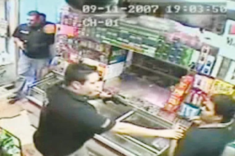Officer Tom Tolstoy (center, with gun) subdues owner Jose Duran as Officer Jeffrey Cujdik enters a bodega in a 2007 raid. Cujdik will be fired, and three other officers will be suspended and transferred from the narcotics squad, Police Commissioner Charles H. Ramsey said Monday.