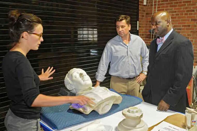 Photos: CLEM MURRAY / Staff photographerA MISSING 134-year-old bust of African Methodist Episcopal founder Bishop Richard Allen (top) has been found at Wilberforce University. Alisa Vignalo (bottom, far left) explains the bust's restoration to John Carr (center), of Milner & Carr Conservation, and the Rev. Mark Tyler, of Mother Bethel AME Church, which Allen founded.