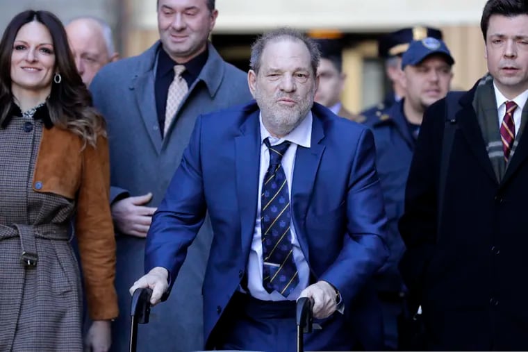 Harvey Weinstein, center, leaves a Manhattan courthouse after closing arguments in his rape trial in New York, Friday, Feb. 14, 2020.