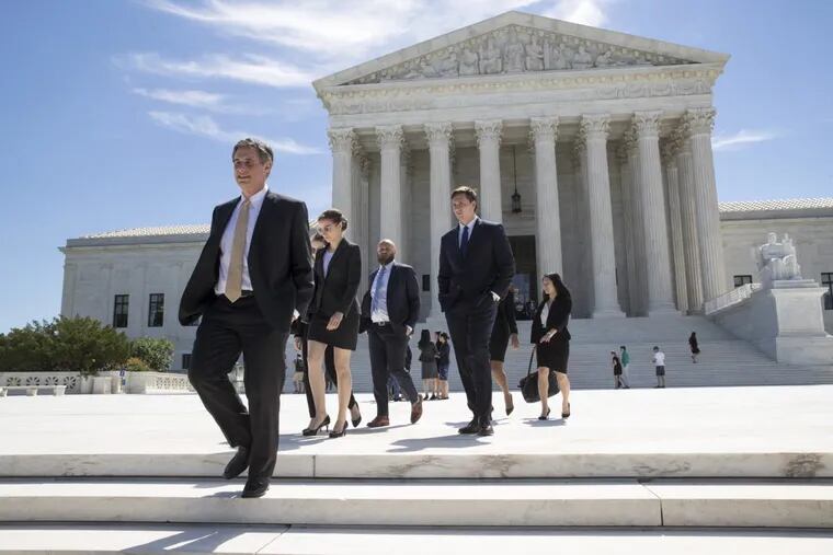 People leave the Supreme Court as justices issued their final rulings for the term, in Washington, Monday, June 26, 2017. The high court is letting a limited version of the Trump administration ban on travel from six mostly Muslim countries to take effect, a victory for President Donald Trump in the biggest legal controversy of his young presidency. (AP Photo/J. Scott Applewhite) .