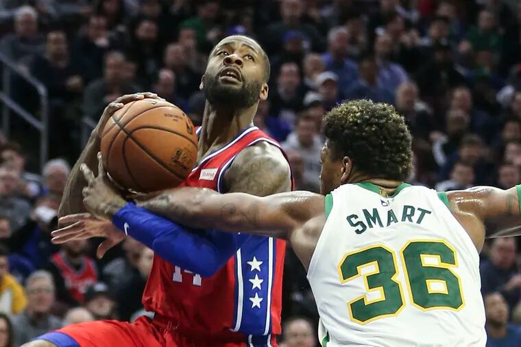 Sixers' Jonathon Simmons gets fouled by Celtics' Marcus Smart during the third quarter at the Wells Fargo Center in Philadelphia, Feb. 12.