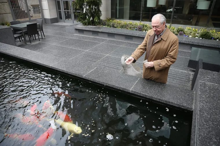 Parkway CEO Joe Zuritsky feeds koi outside his condo building in the Rittenhouse Square neighborhood.