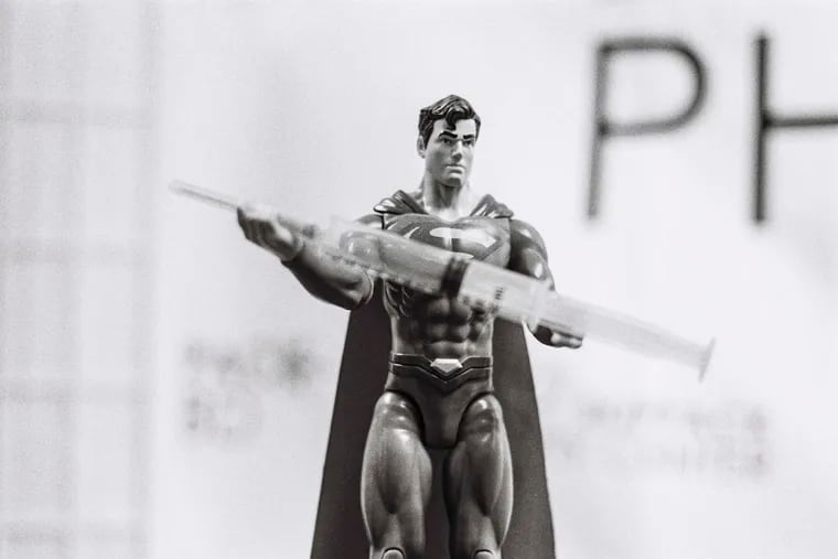 A superman action figure holding a needle is seen in Skippack Pharmacy. The pediatric COVID-19 vaccine was being distributed by Mayank Amin, who owns the Skippack Pharmacy, on, Wednesday, November 3, 2021, a day after children aged 5 to 11 were approved for the shot. Amin dressed as the super hero.
