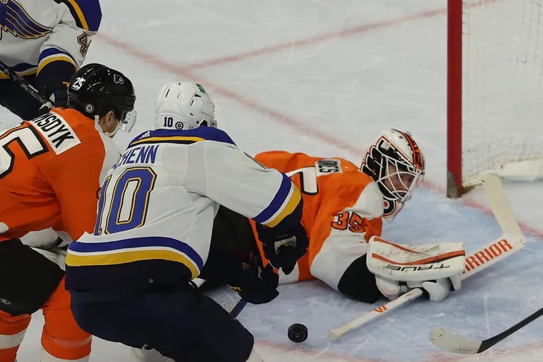 Brayden Schenn, center, of the Blues  scores against Martin Jones, right, of the Flyers during the 1st period at the Wells Fargo Center on Feb. 22, 2022