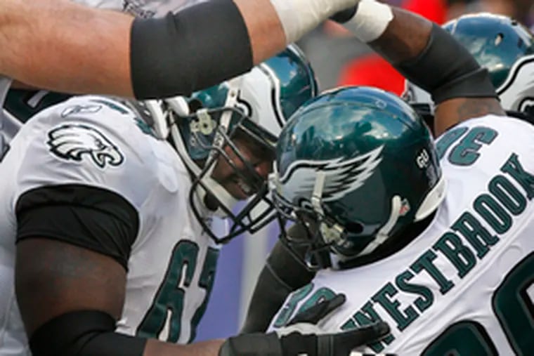 The Eagles&#0039; Brian Westbrook is swarmed by teammates after his 30-yard touchdown run in the second quarter.