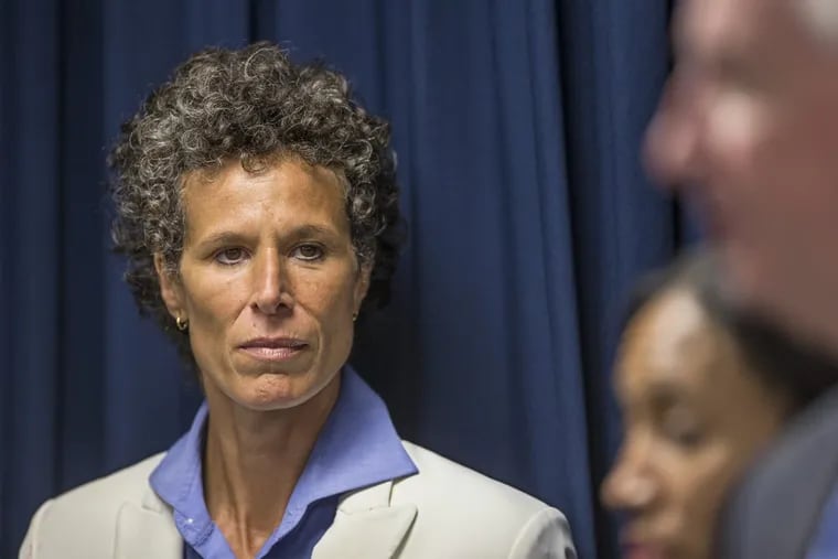 Cosby accuser Andrea Constand, left, listens to Montgomery County District Attorney as he answers questions during the press conference that was held after Bill Cosby was found guilty on all three counts of sexual assault during his retrial in Norristown, PA, on Thursday April 26, 2018.