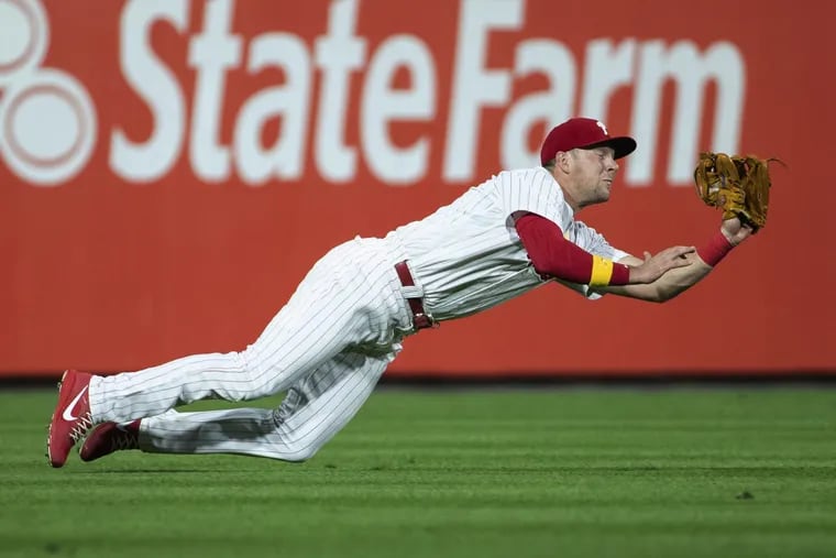 Rhys Hoskins dives to make a catch during an early September game. The natural first baseman played most of the season in left field to mixed results.