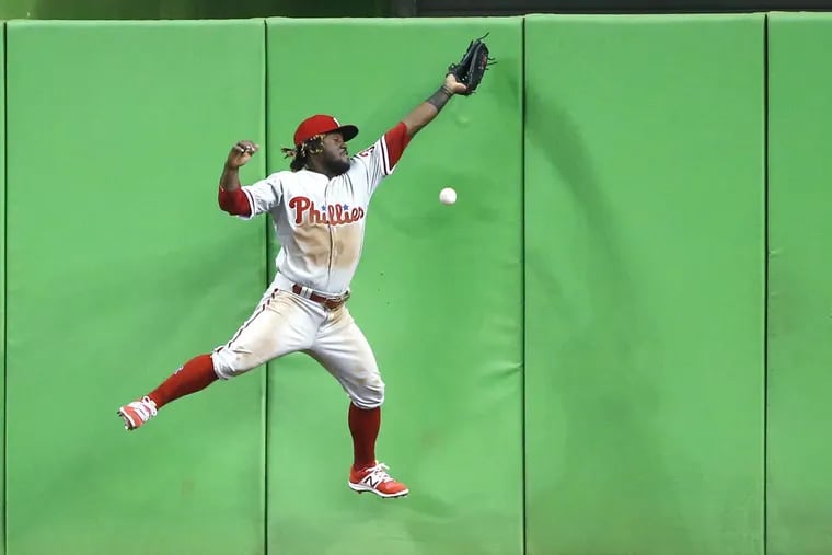 Odubel Herrera is unable to catch a ball hit by Miami’s Derek Dietrich for a double that scored Martin Prado during the third inning on Monday.