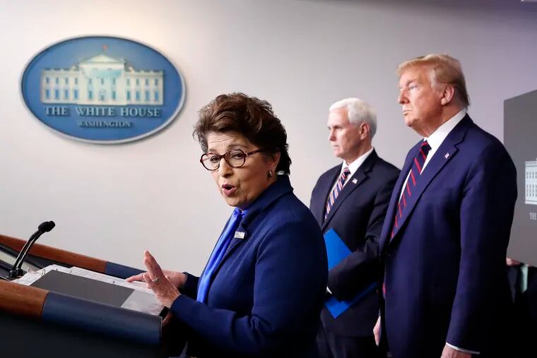 Jovita Carranza, administrator of the Small Business Administration, speaks about the coronavirus Thursday as Vice President Mike Pence, President Donald Trump listen.